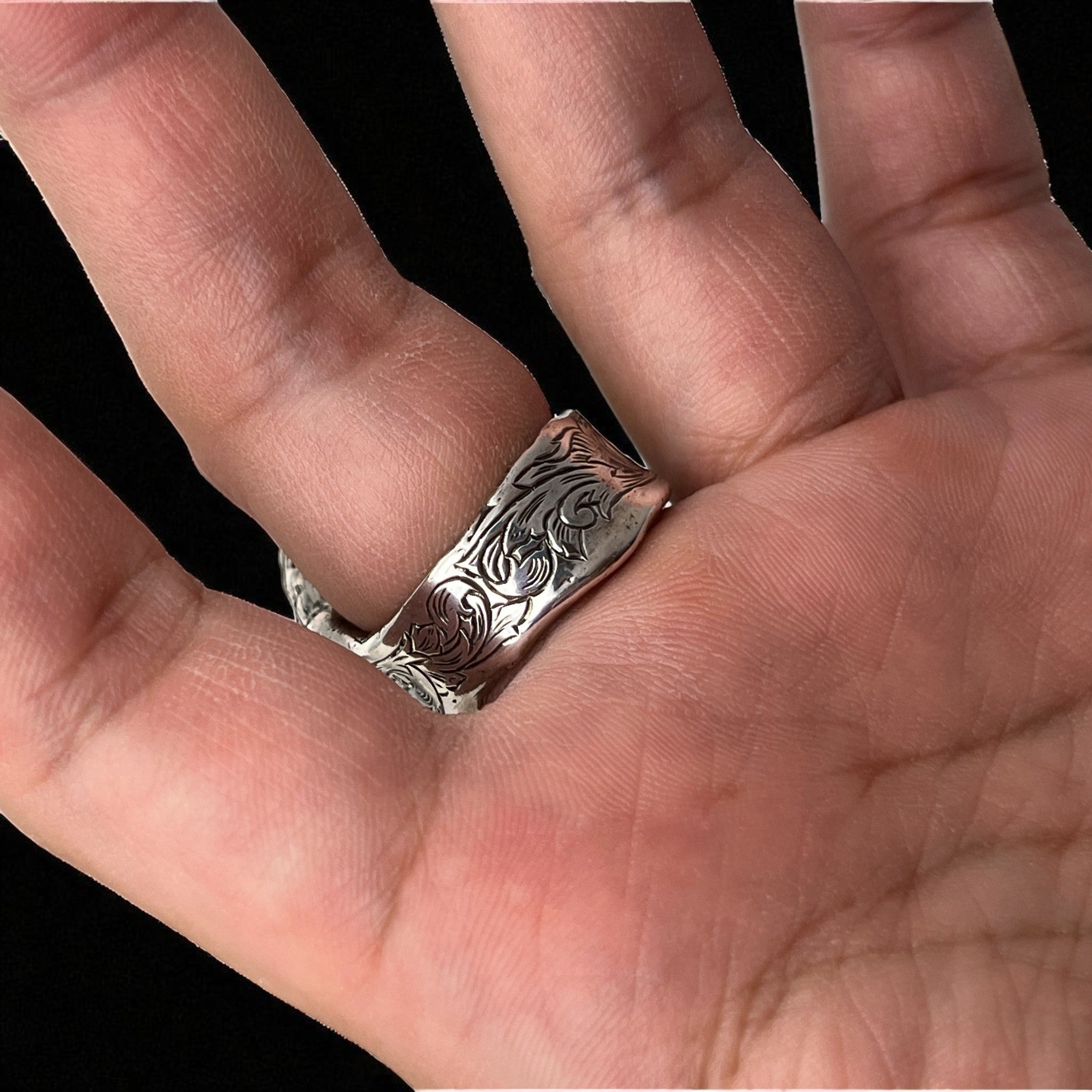 シルバーリング mythⅡ の着用写真。手のひら側から映した角度で、リングのアーム部分に刻まれた繊細な植物模様のエングレービング彫金を強調したデザイン。
